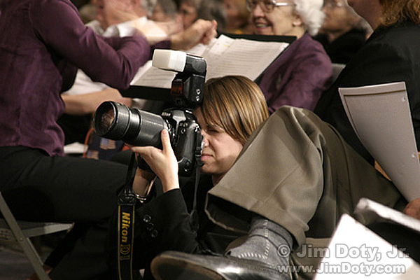 Photographer hand holding a camera.